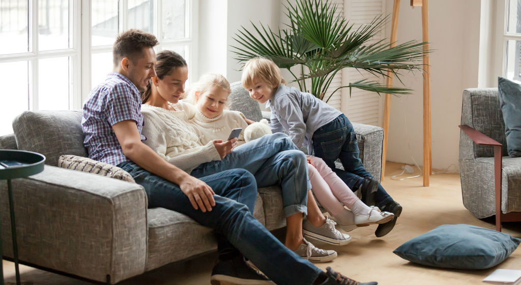 happy-family-with-children-using-smart-devic-in-living-room