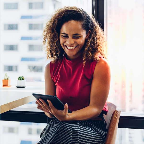 Young professional woman using tablet in modern office